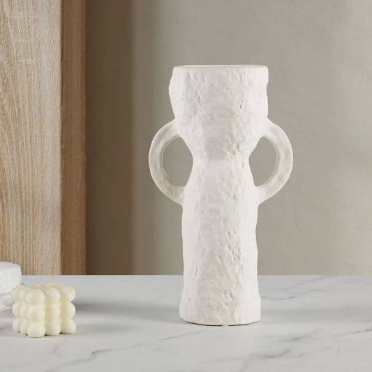 White textured vase on a marble surface with a neutral background