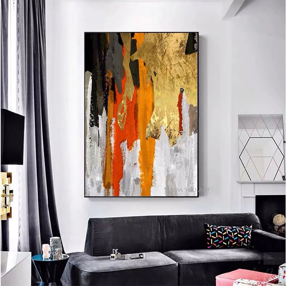 Abstract art painting on a wall above a black sofa in a living room.