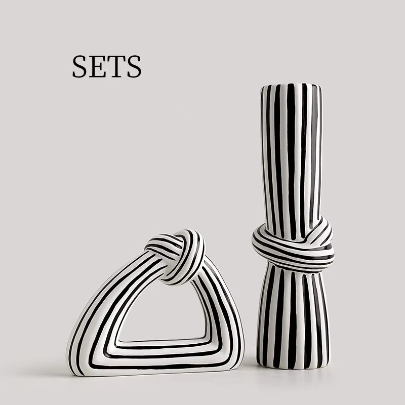 Two black and white striped ceramic vases on a light gray background with 'SETS' text.
