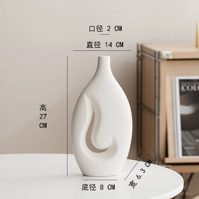 White decorative vase with measurements on a white surface