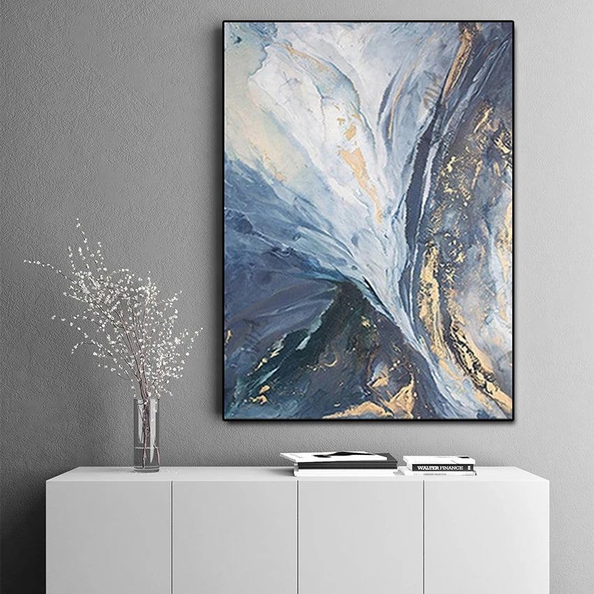 Abstract art piece on a gray wall above a white cabinet.