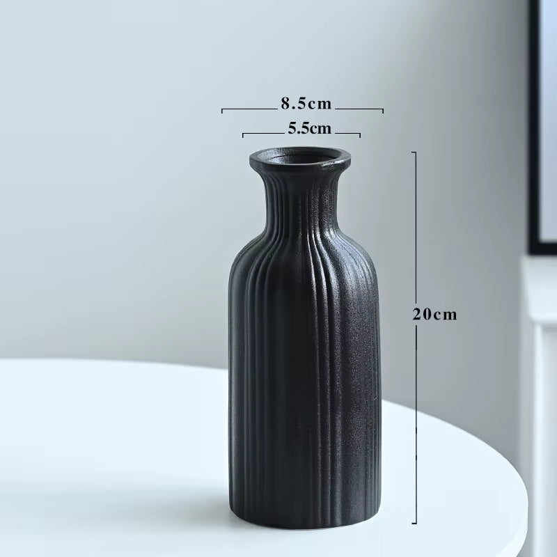 Black textured vase on a white surface with dimensions indicated
