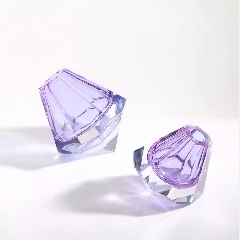 Two purple crystal objects on a white background
