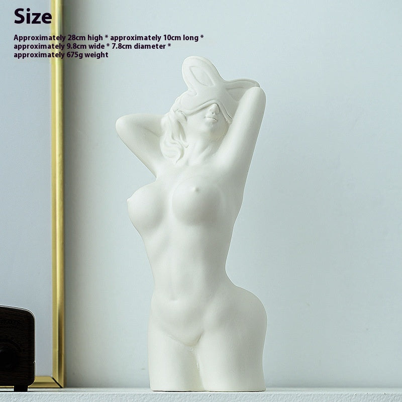 White abstract sculpture of a nude figure on a light gray background