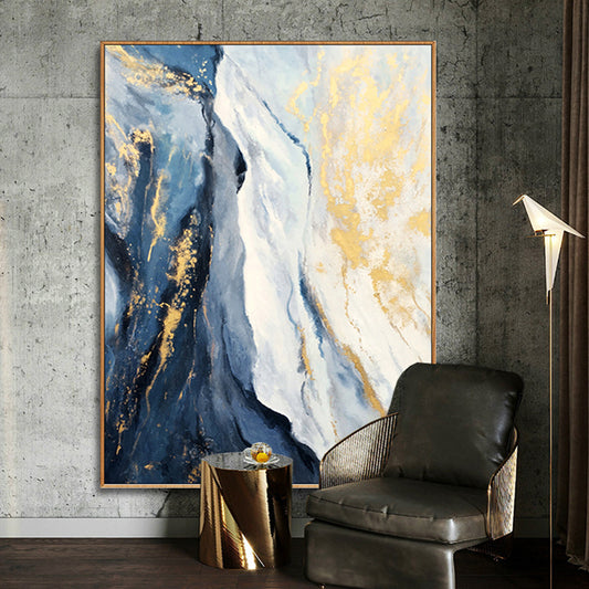 Abstract art piece with blue, gold, and white colors in a modern interior setting.