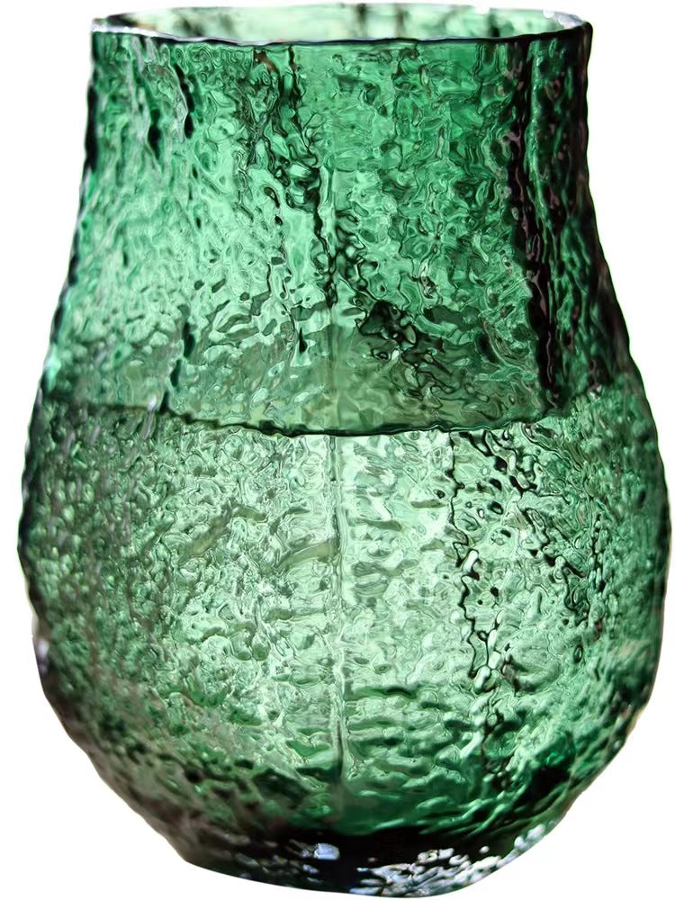 Green textured glass vase on a white background