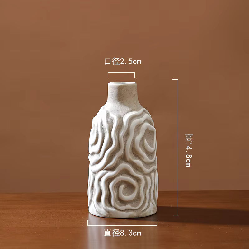 White ceramic vase with wavy patterns on a brown background