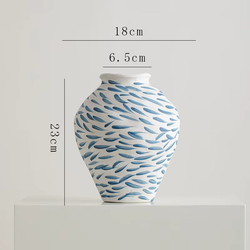 Ceramic vase with blue wave pattern and measurements on a light gray background
