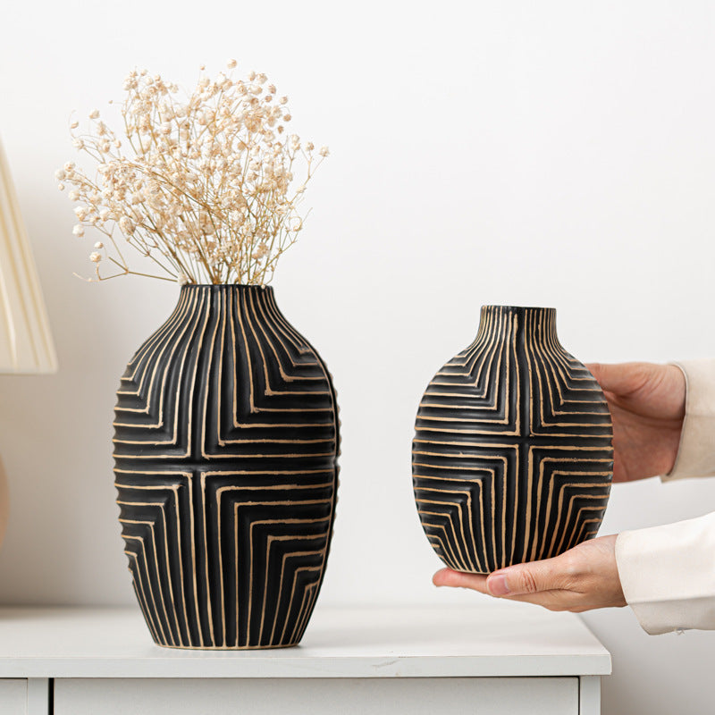 Two decorative vases with geometric patterns on a white surface.