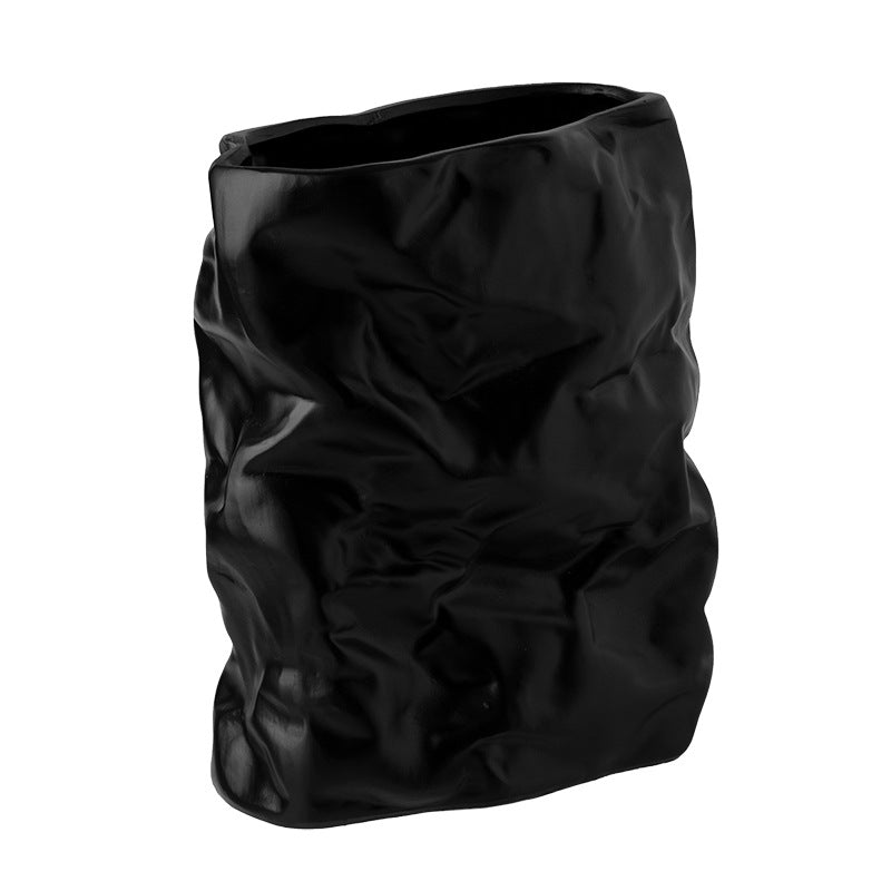 Black crumpled plastic bag on a white background