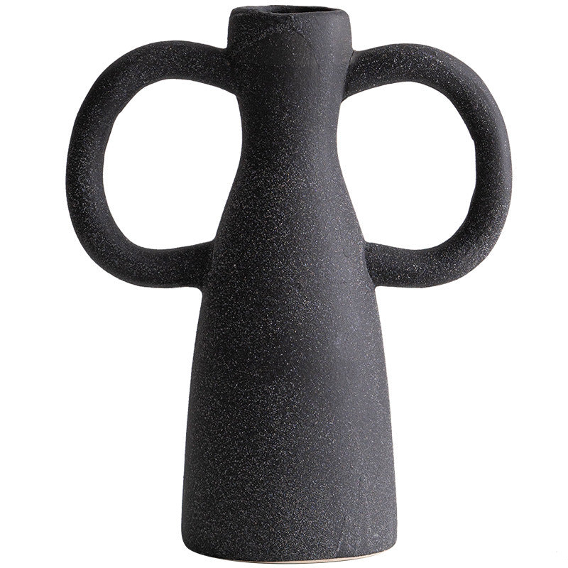 Black ceramic vase with two handles on a white background