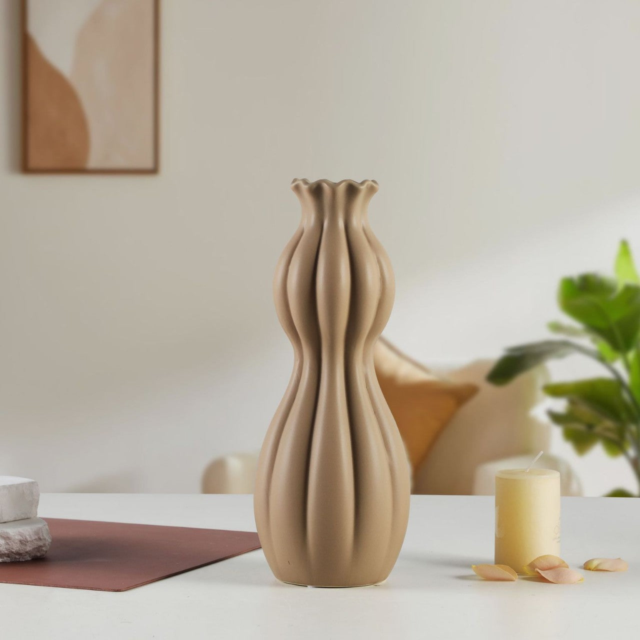 Beige ceramic vase on a table with a blurred background