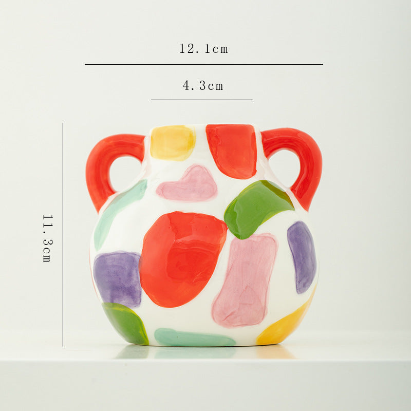 Colorful ceramic vase with measurements on a white background