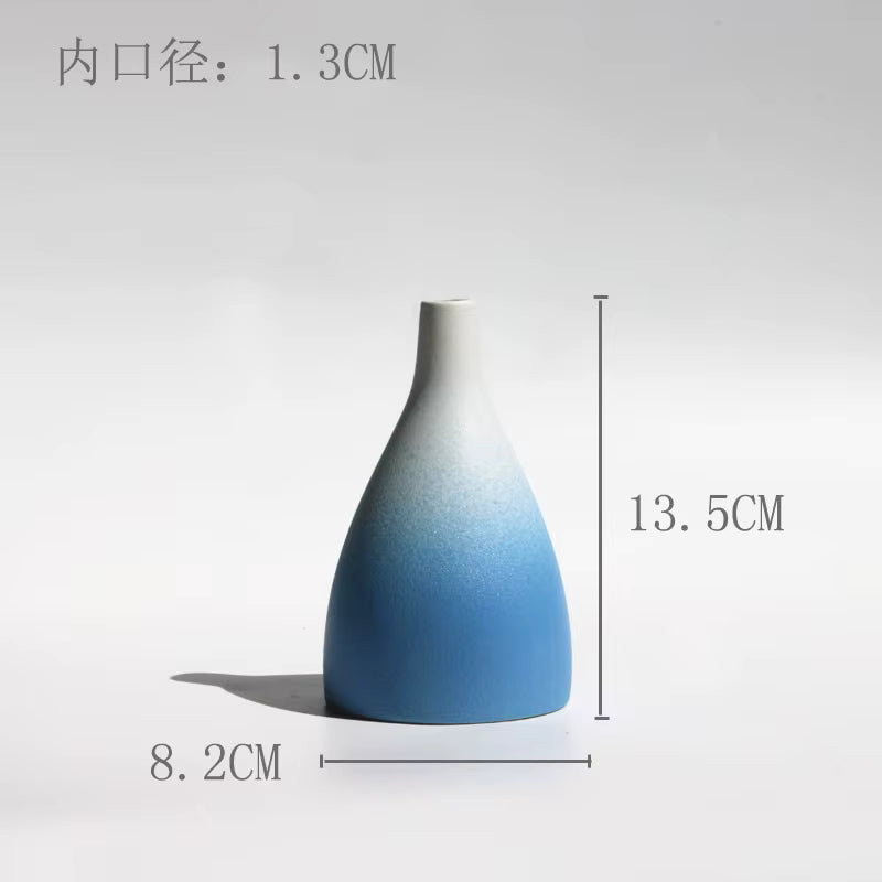 Gradient blue and white vase with measurements on a light gray background