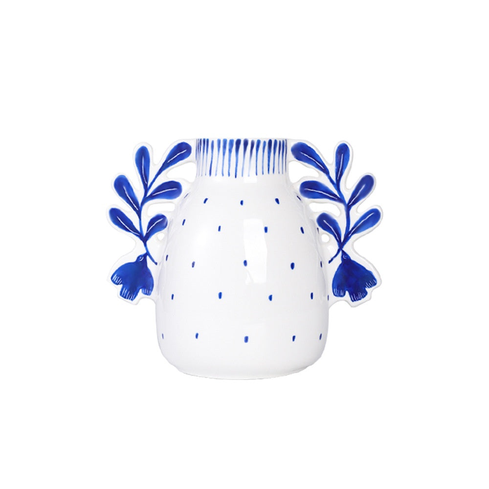 White mug with blue floral designs on a white background