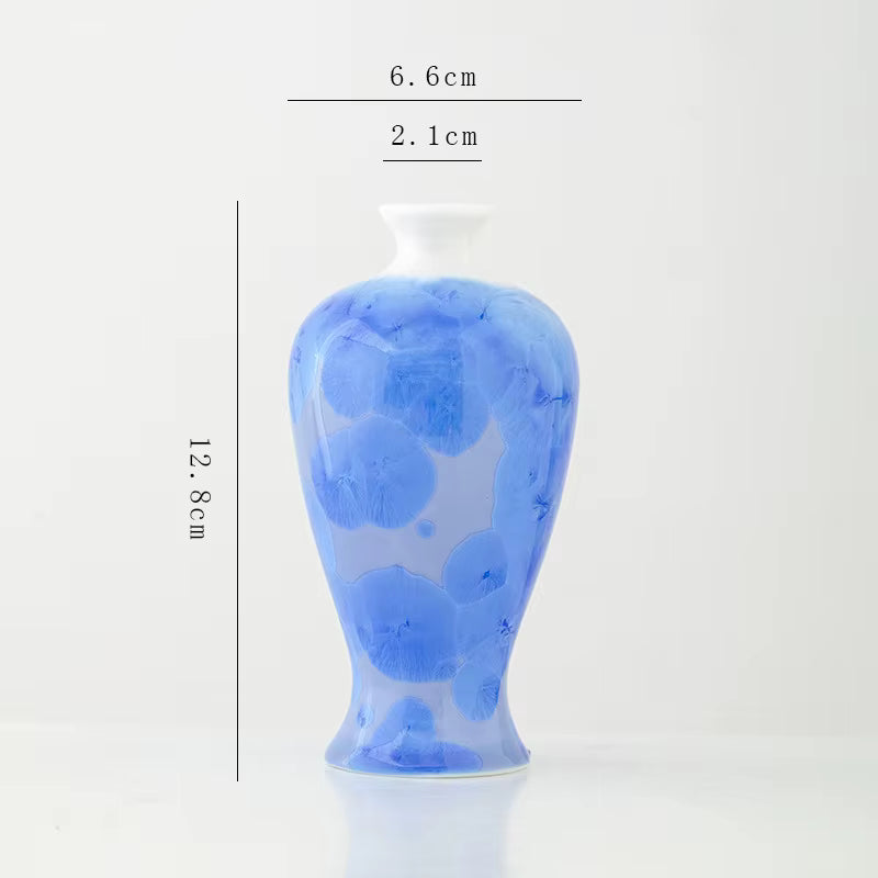 Blue ceramic vase with measurements on a white background