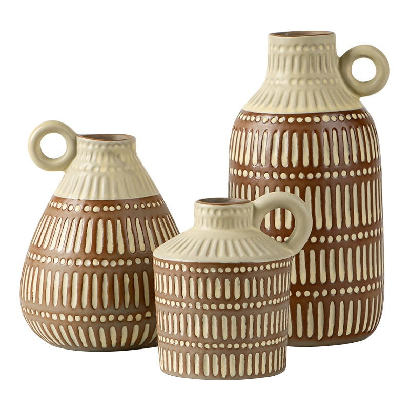 Three ceramic vases with brown and beige patterns on a white background