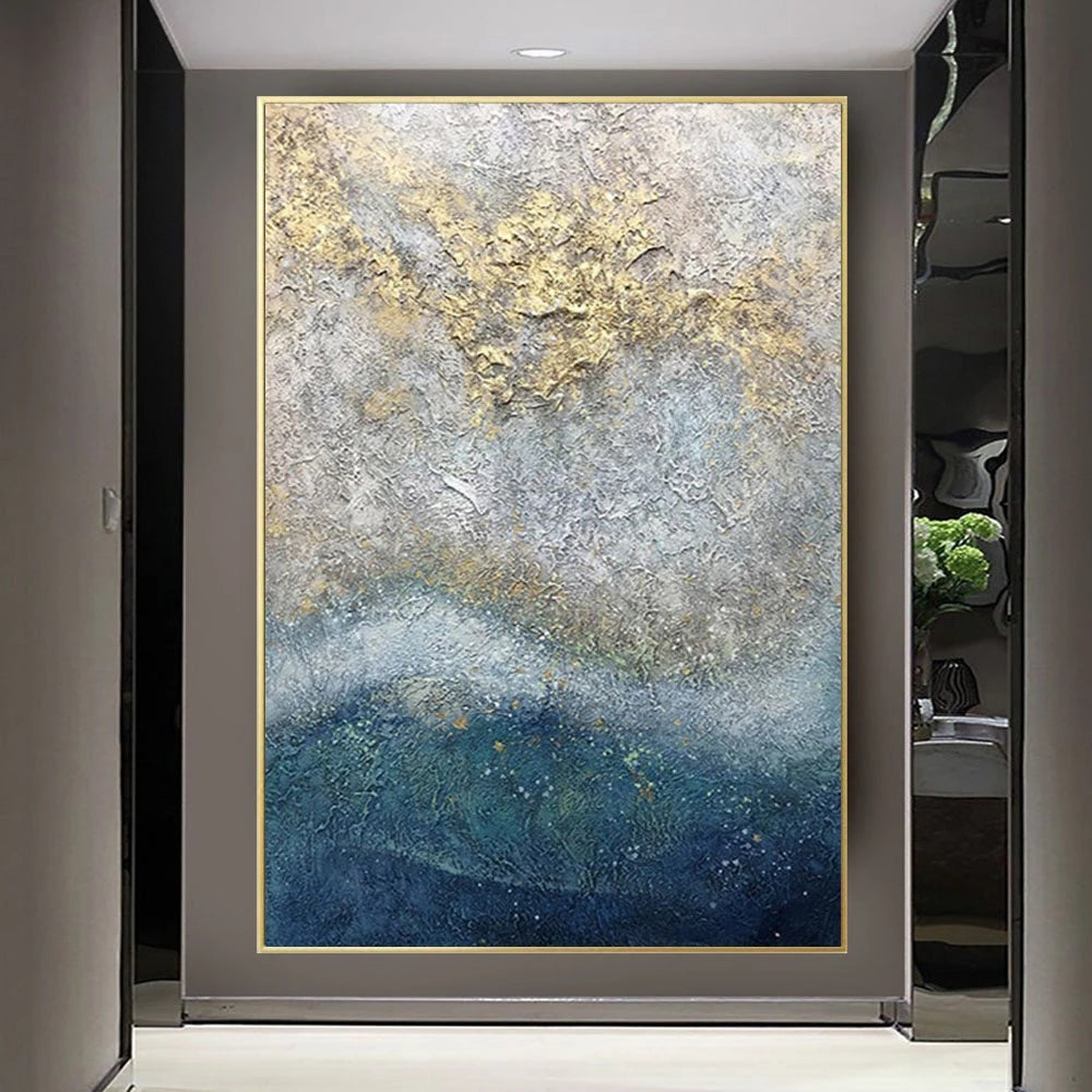 Abstract painting with gold and blue tones in a modern interior setting