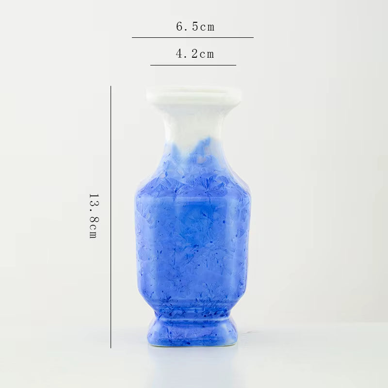 Blue ceramic vase with measurements on a white background
