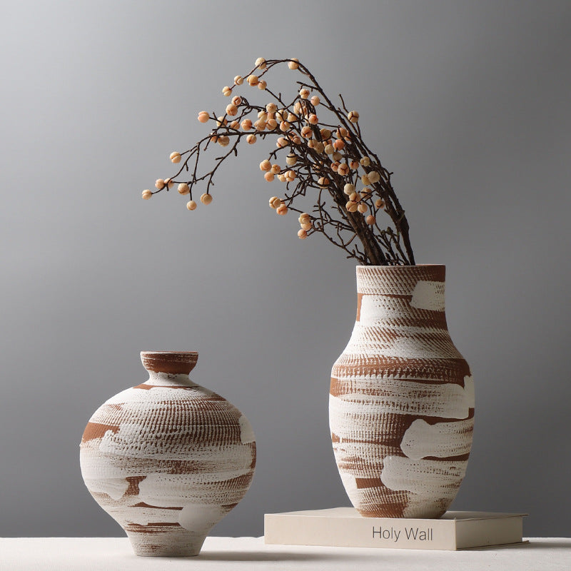 Two ceramic vases with textured design on a gray background