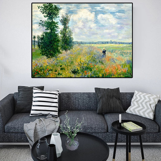Living room with a gray sofa, decorative pillows, and a large framed painting of a landscape.