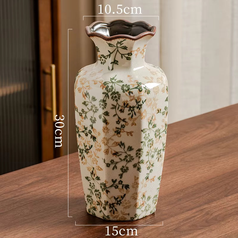 Decorative vase with floral patterns on a wooden surface, showing measurements.