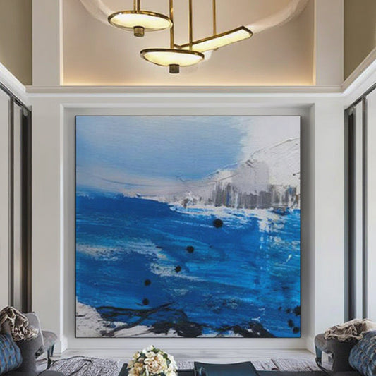 Framed abstract painting with blue and white tones in a modern living room.