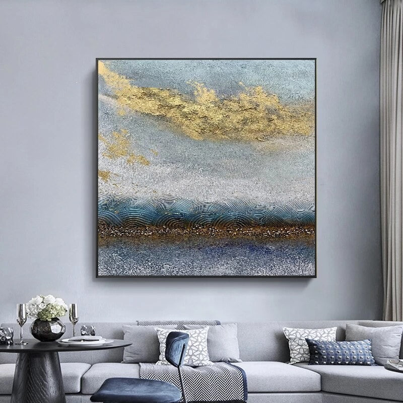 Abstract painting on a wall above a gray sofa in a living room.