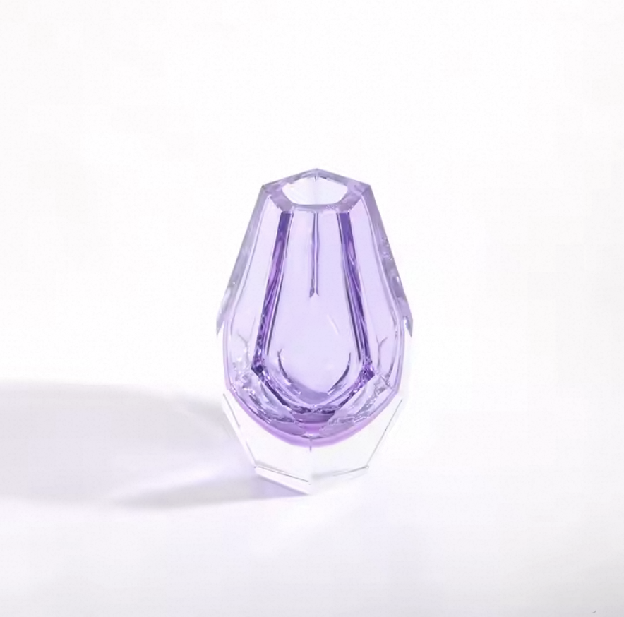 Purple crystal vase on a white background