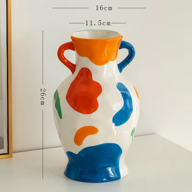Colorful ceramic vase with abstract patterns and measurements on a white background