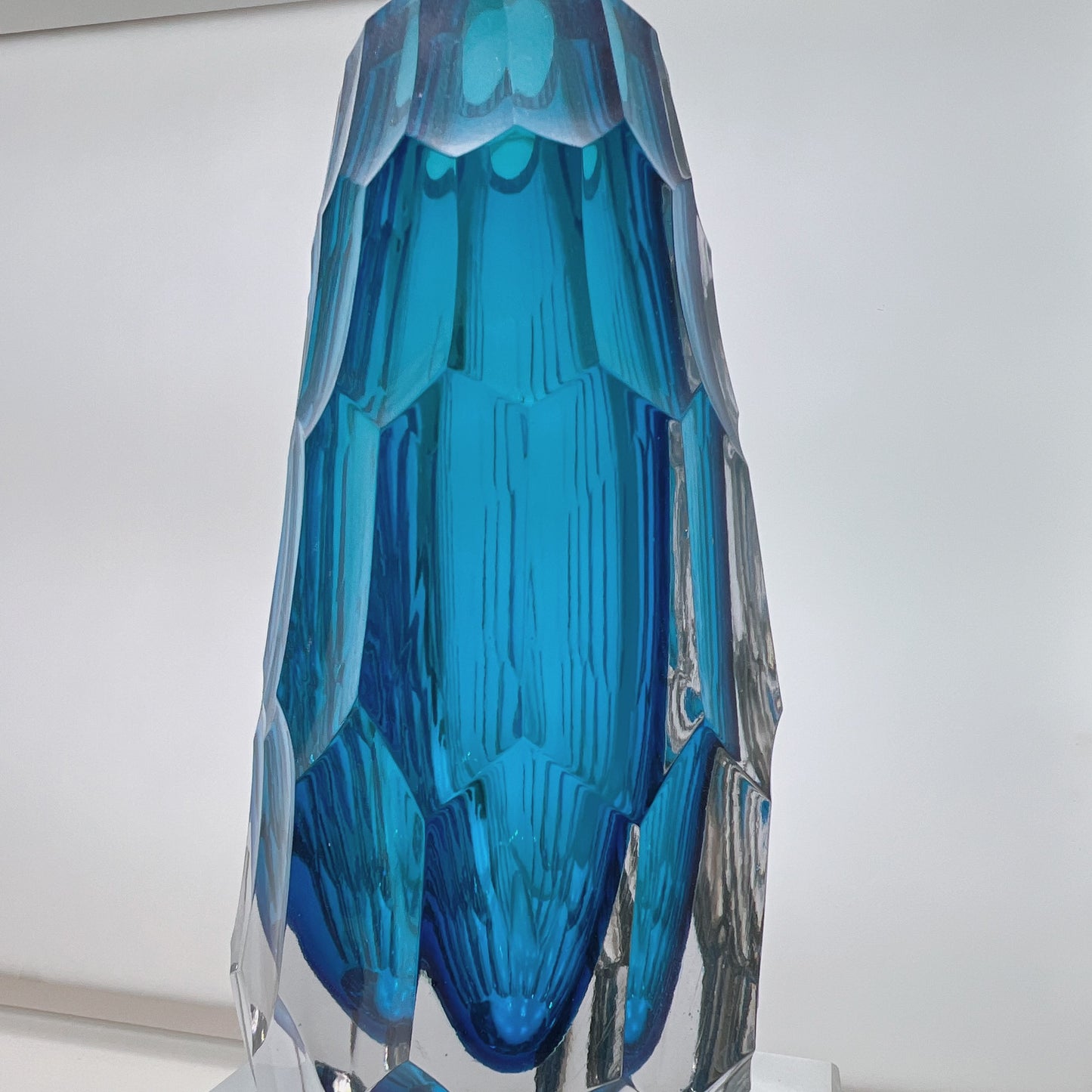 Blue crystal-like object on a white background