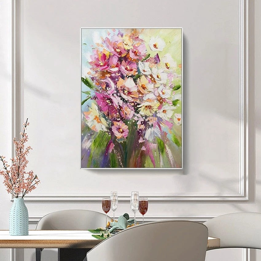 Framed floral painting above a dining table with decorative items.