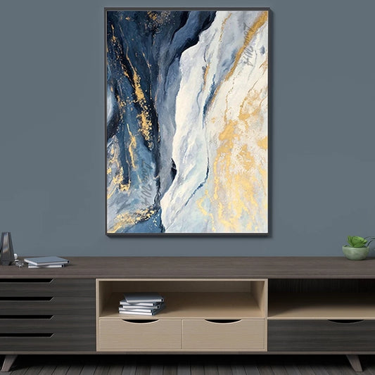 Abstract art piece with blue and gold tones on a gray wall above a wooden entertainment console.