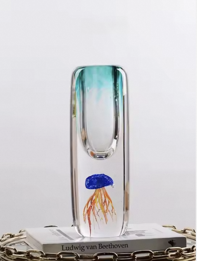 Glass vase with a jellyfish design on a white surface