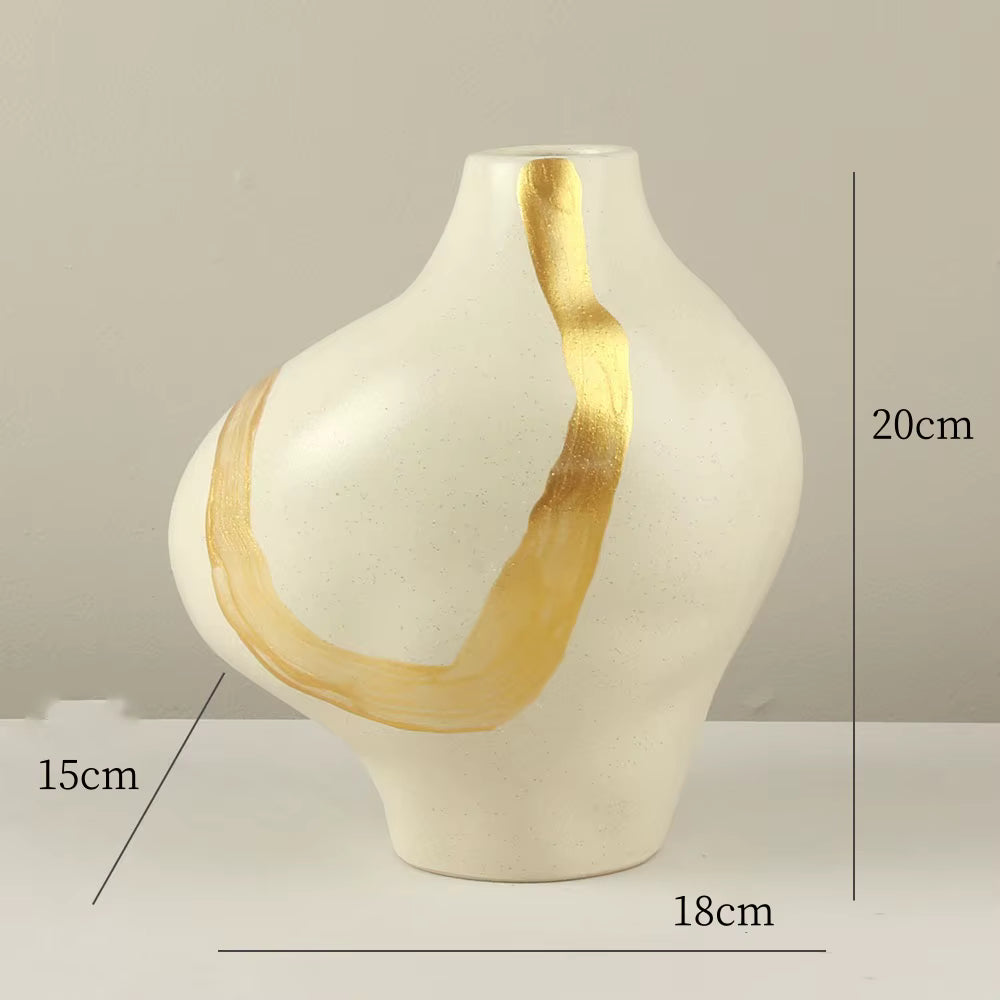 White vase with gold accents and measurements on a neutral background