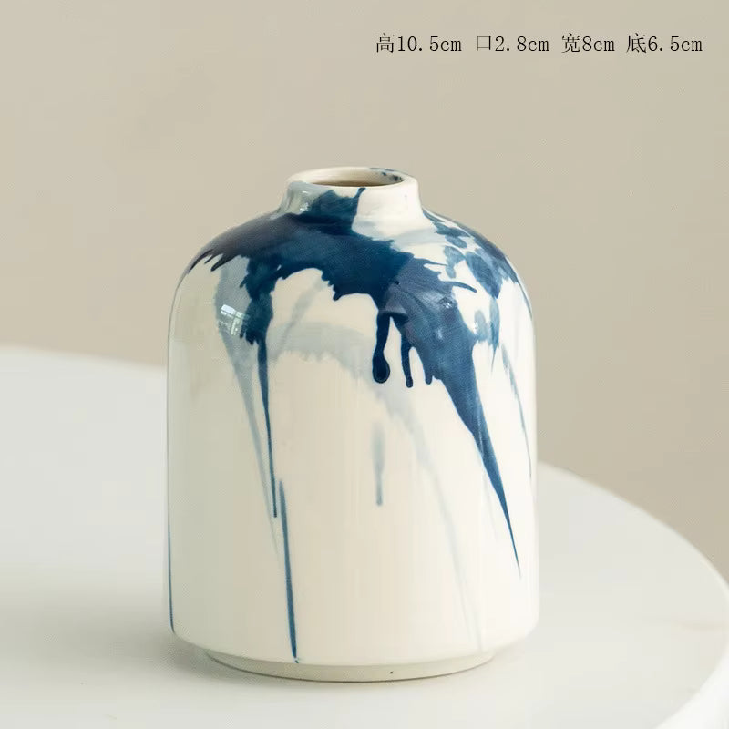 Ceramic vase with blue and white design on a light gray background