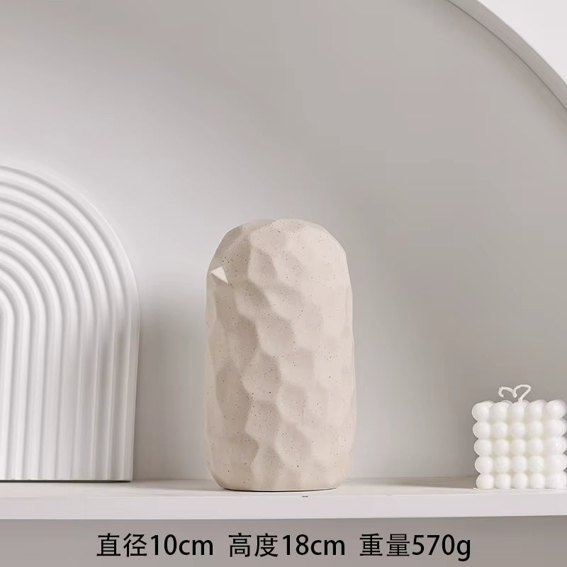 Beige ceramic vase on a shelf with minimalistic design