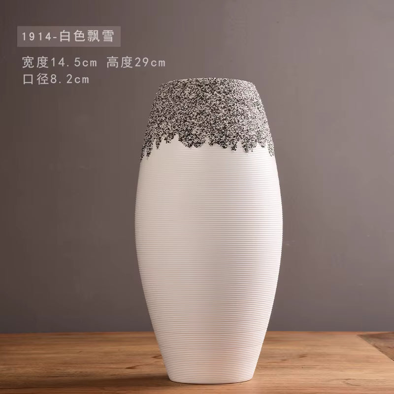 White vase with decorative top on a wooden surface and gray background