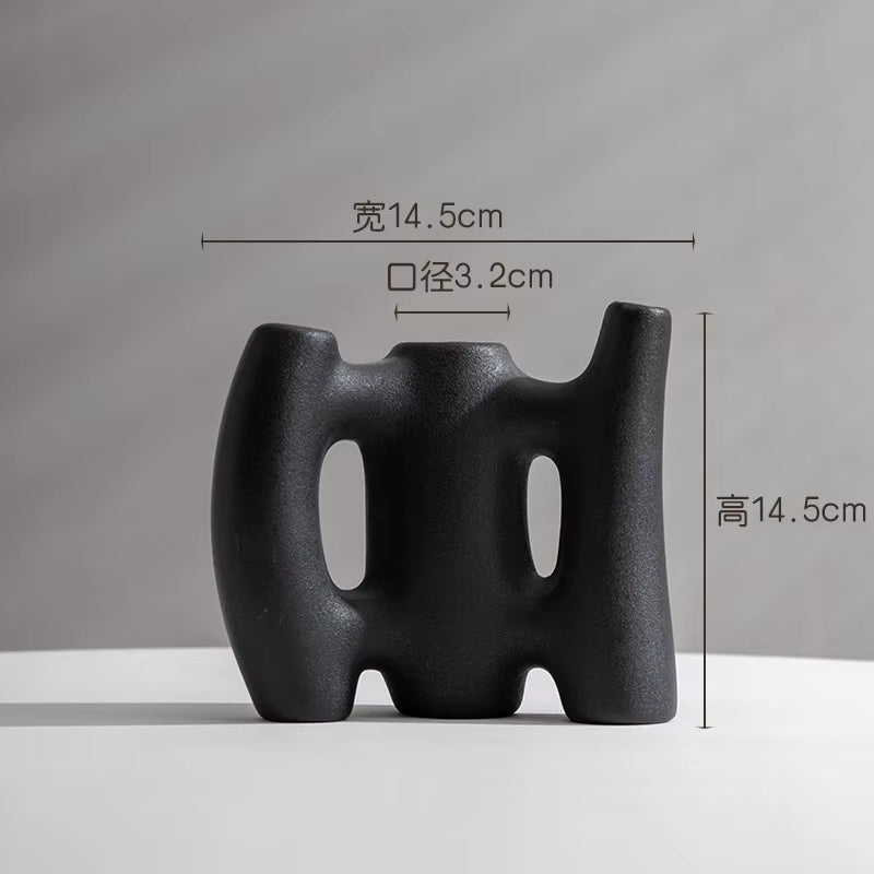 Black abstract vase with measurements on a gray background