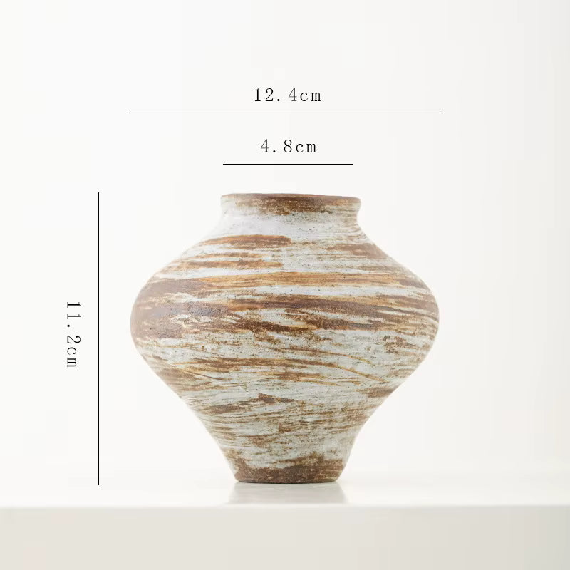 Ceramic vase with measurement markings on a white background
