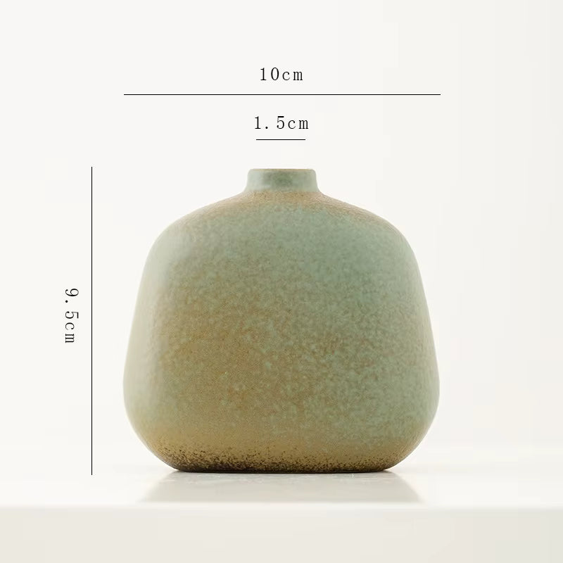 Green ceramic vase with dimensions on a white background