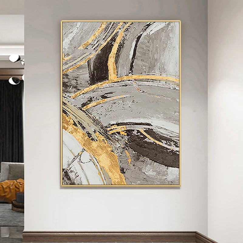 Abstract art painting with gold accents on a wall in a modern interior setting