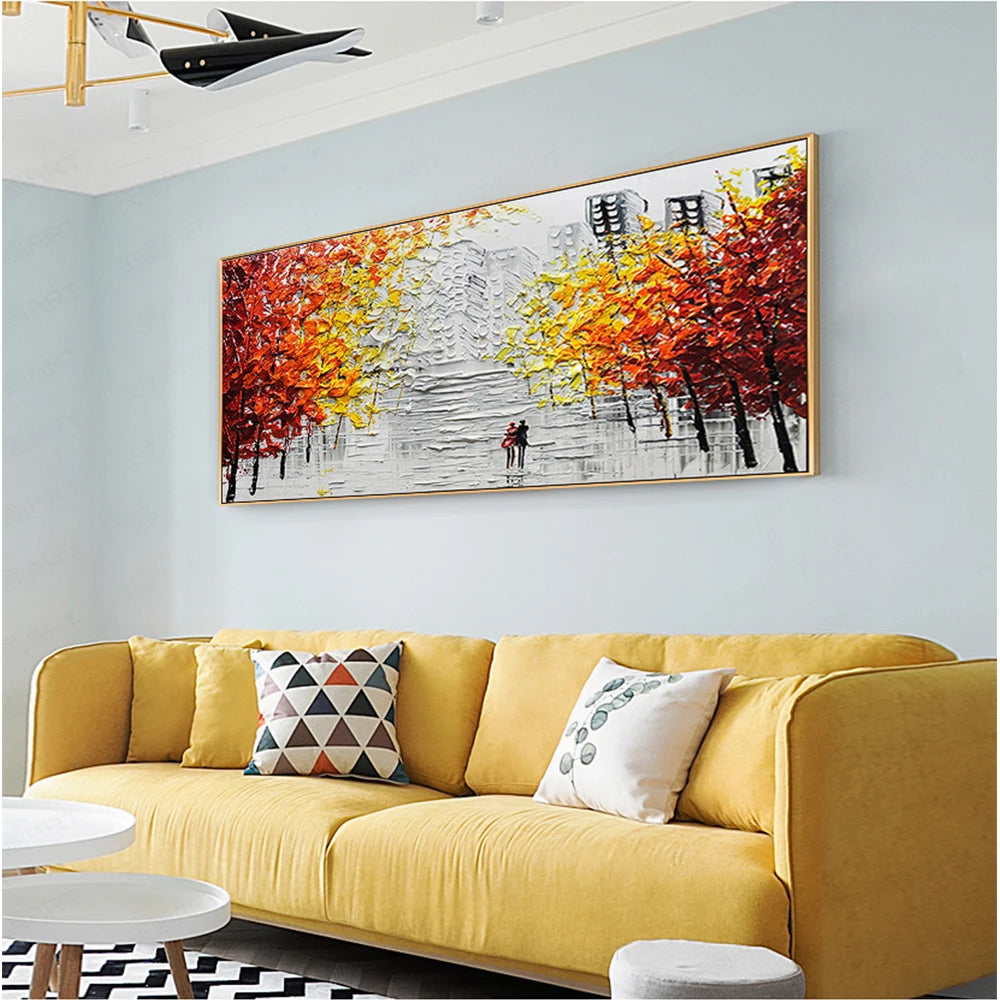 Yellow sofa with decorative pillows in a living room with a large abstract painting on the wall.