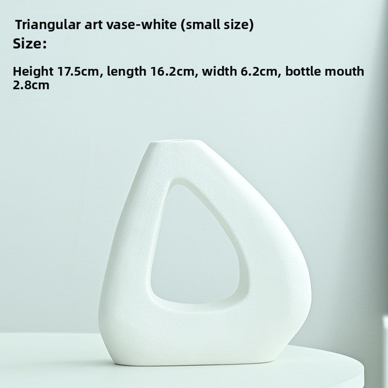 White triangular art vase on a light gray background with size information.