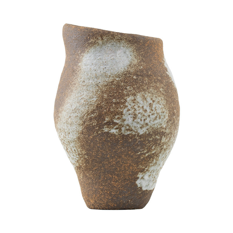 Rustic ceramic vase with a textured surface on a white background