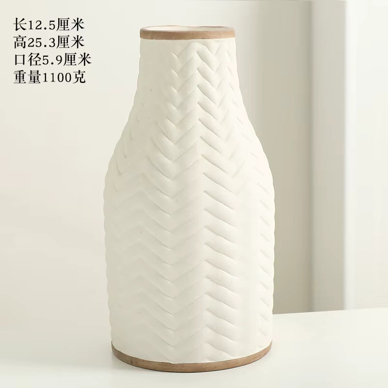 White textured vase with wooden base on a light background