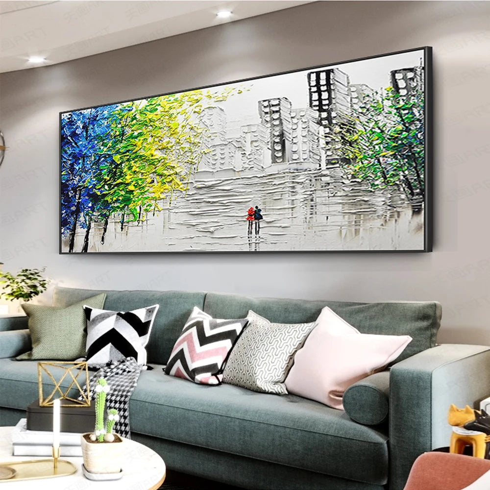 Sofa with decorative pillows in a living room with a large abstract painting on the wall.