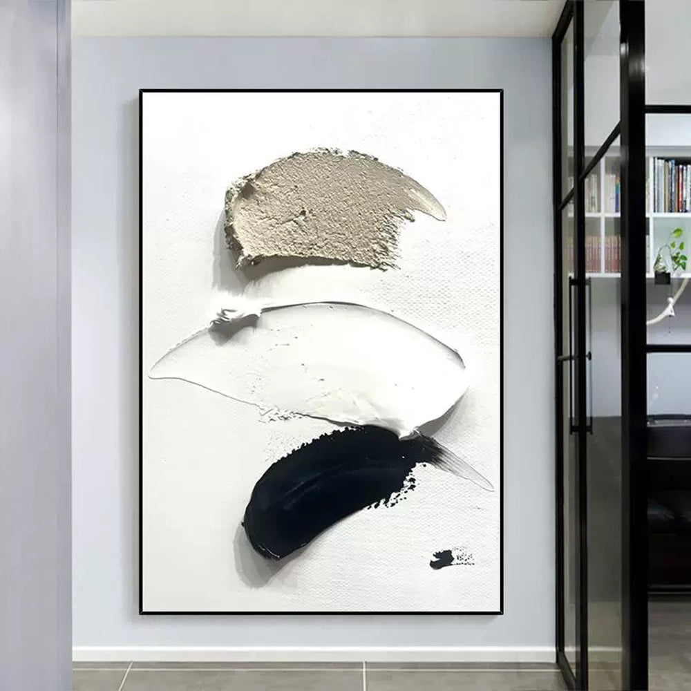 Abstract art piece with black, white, and gray brush strokes in a modern interior setting.