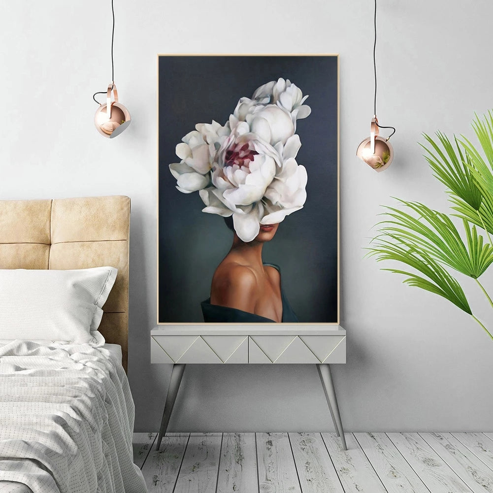 Framed artwork of a woman with floral headpiece in a bedroom setting