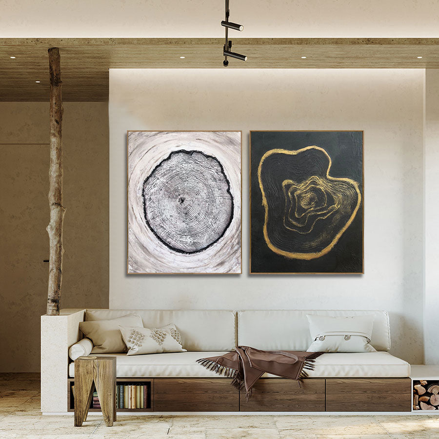 Modern living room with a white sofa, wooden side table, and abstract wall art.